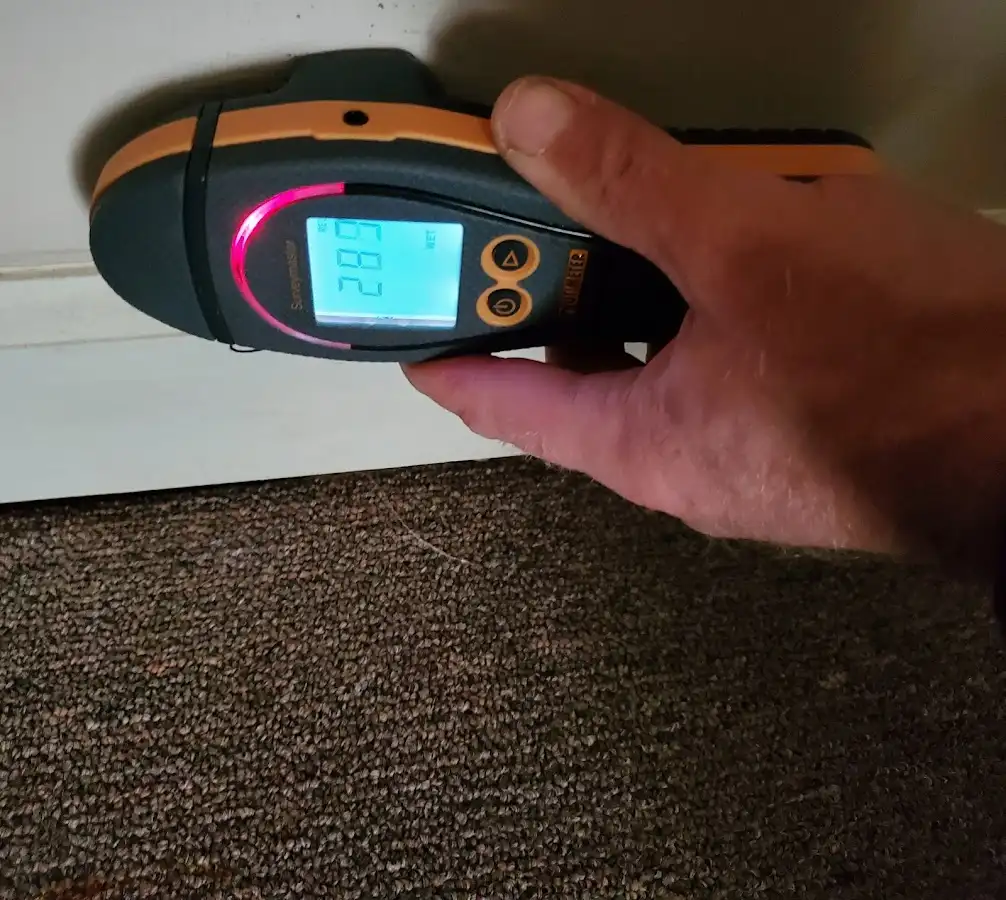 Moisture detection at baseboard during Storm Damage Restoration in Greenfield